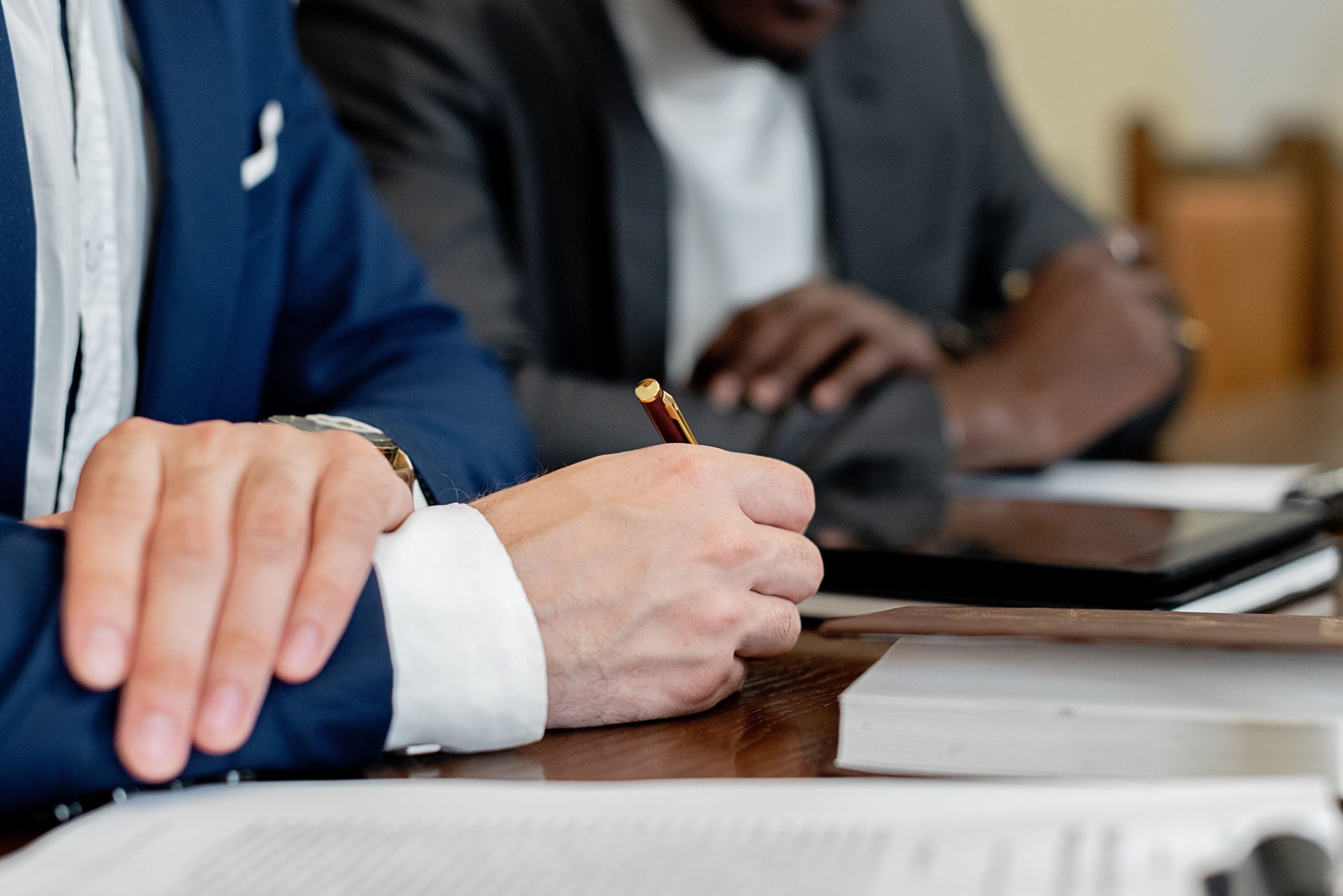closeup of lawyer holding pen viewing documents