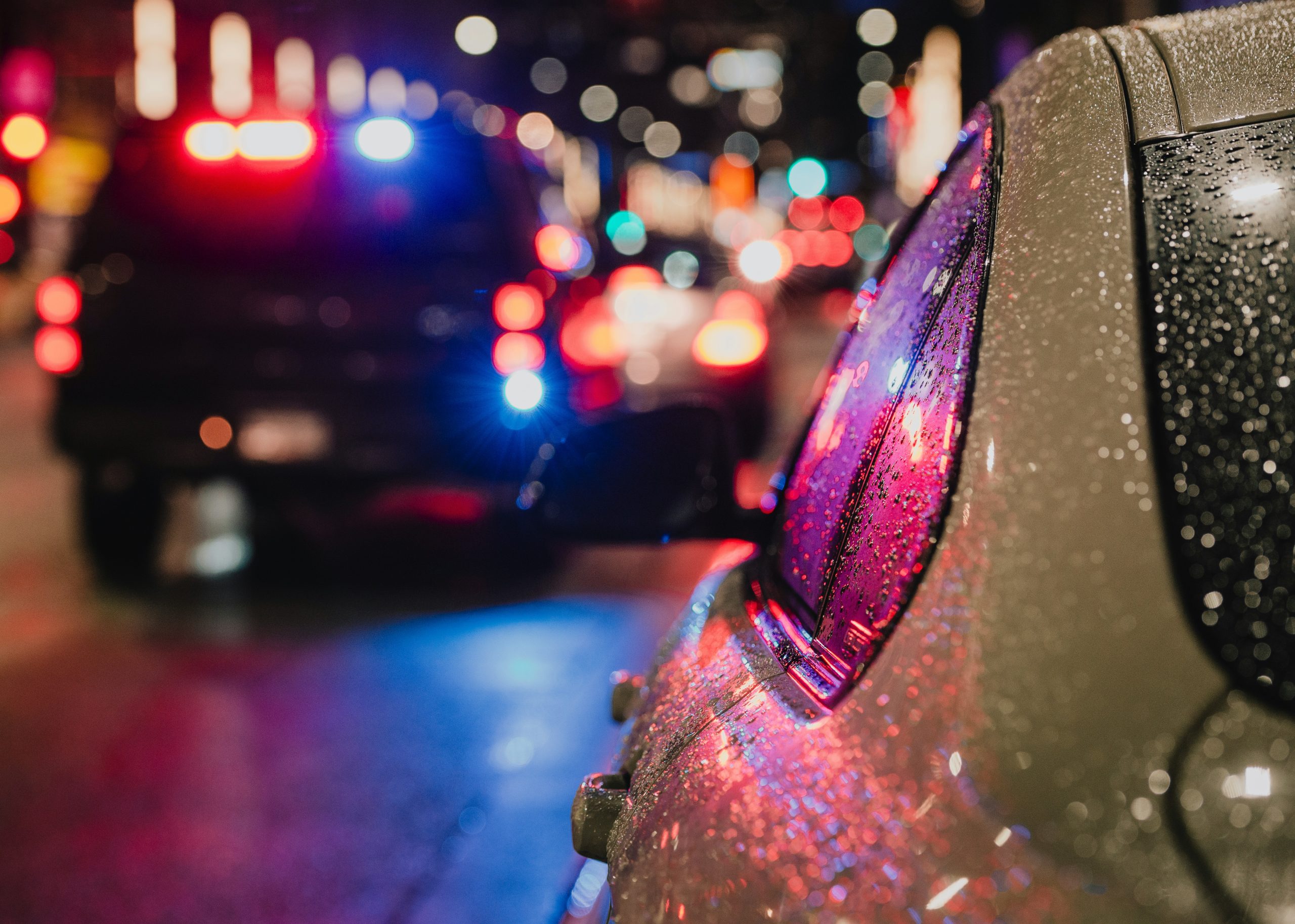 traffic offenses - car with police lights reflecting off