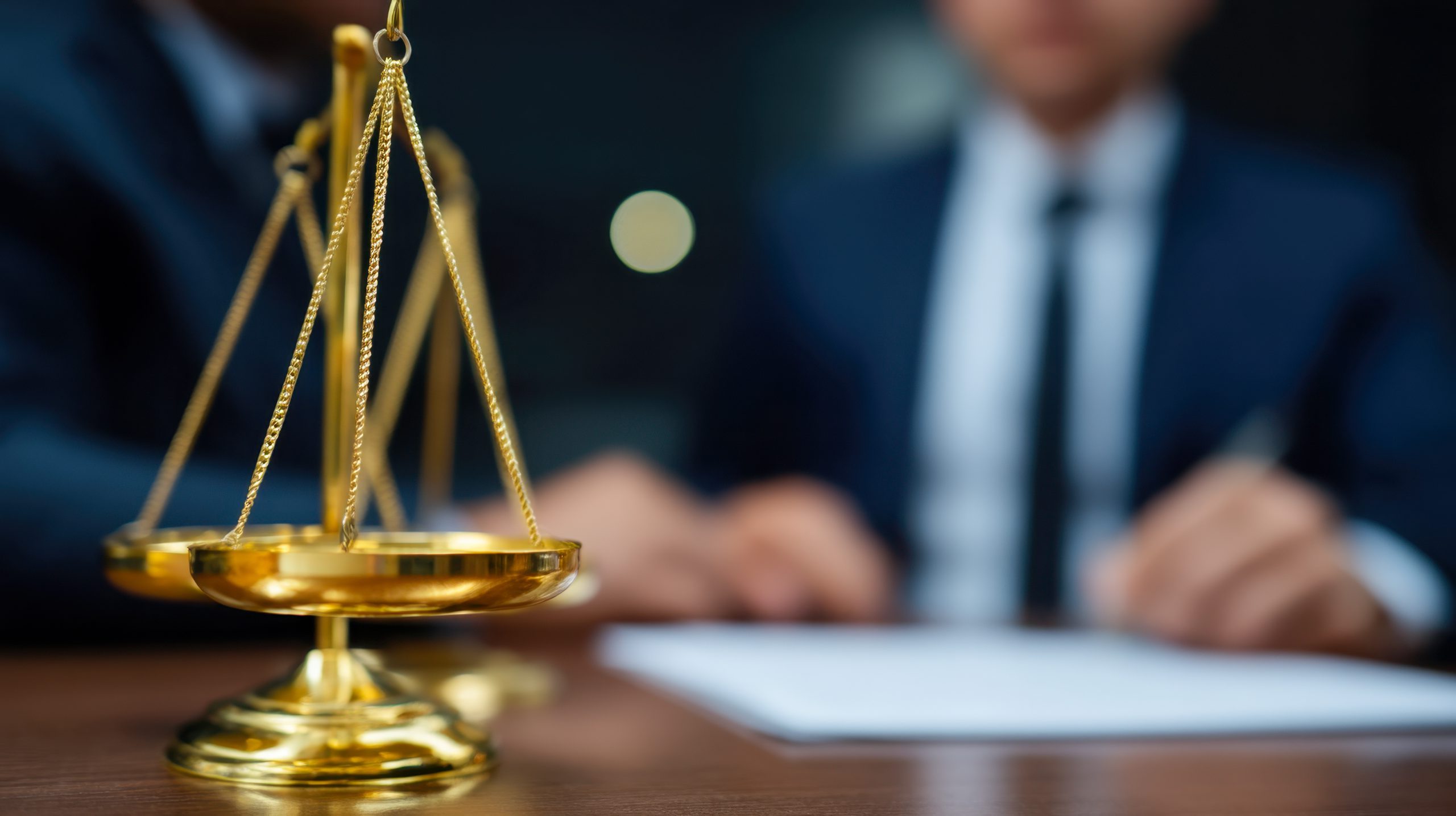 Legal consultation with scales of justice in close proximity at a professional office setting